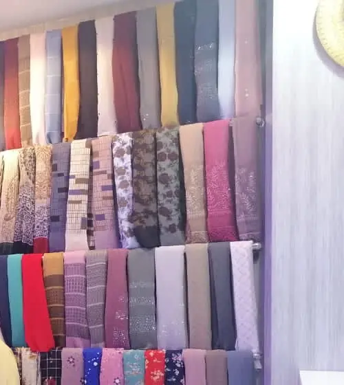 Shelas folded on the shelves at Red Chic