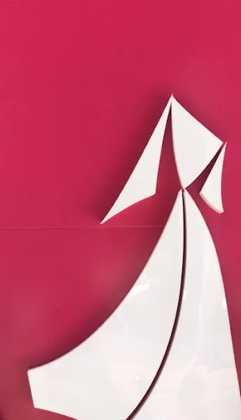 The white Red Chic abaya logo on the shop's raspberry wall